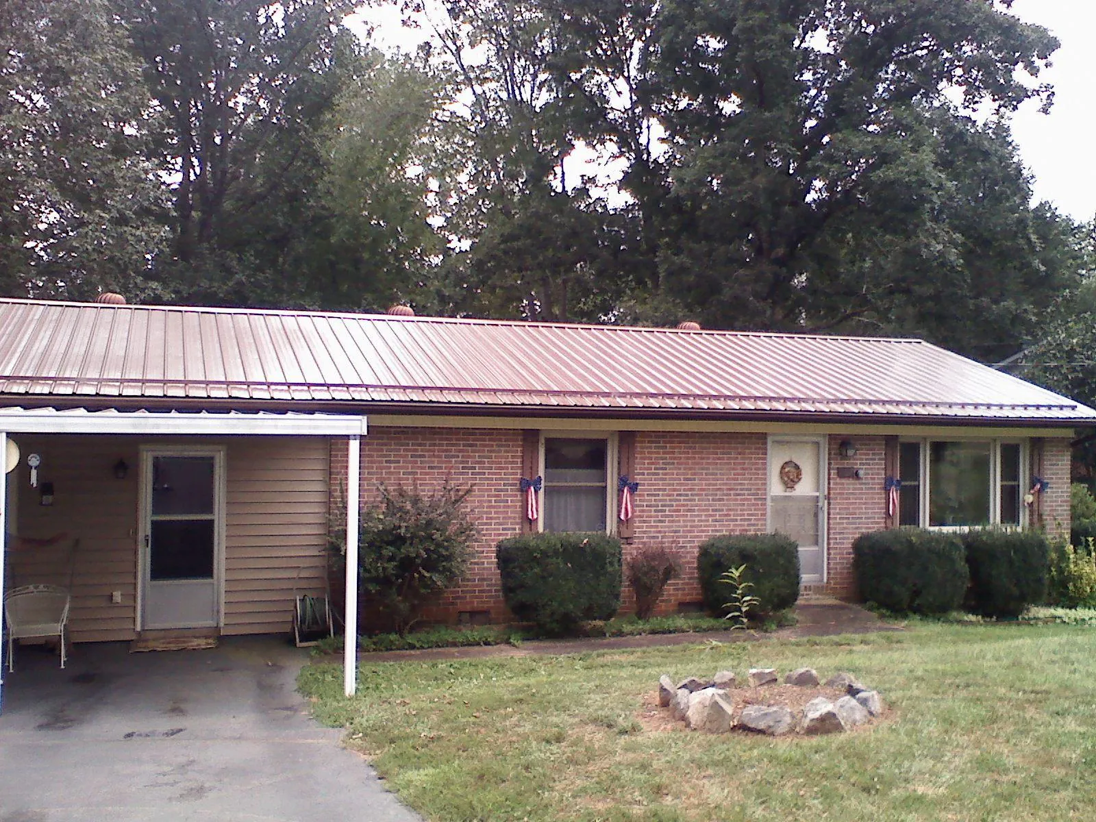 Bronze metal roof and carport on a brick ranch home — Roof Repair work by our crew in Orangeville